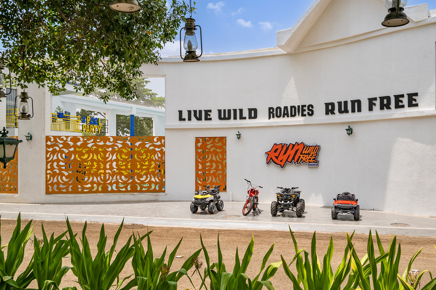 Adventure park entry zone at Roadies Rostel with ATVs and bold signage, perfect for thrill seekers near Ahmedabad