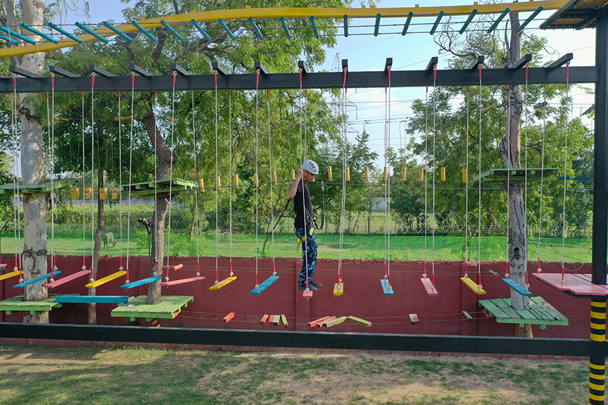 Three-floor rope course surrounded by greenery at Roadies Rostel ARC Resort, an exciting challenge for all ages