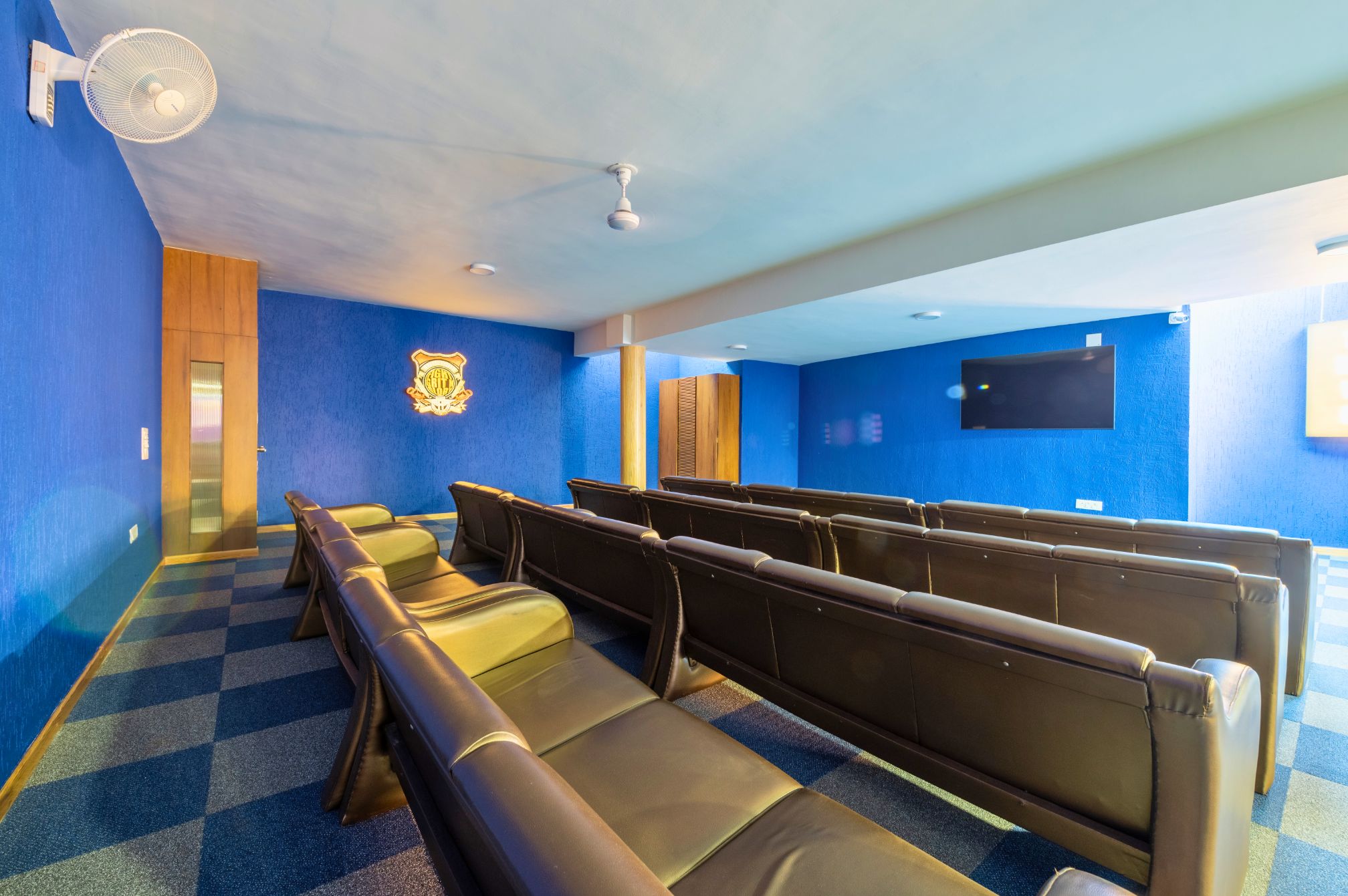 Mini theatre with leather seating and TV screen at resort