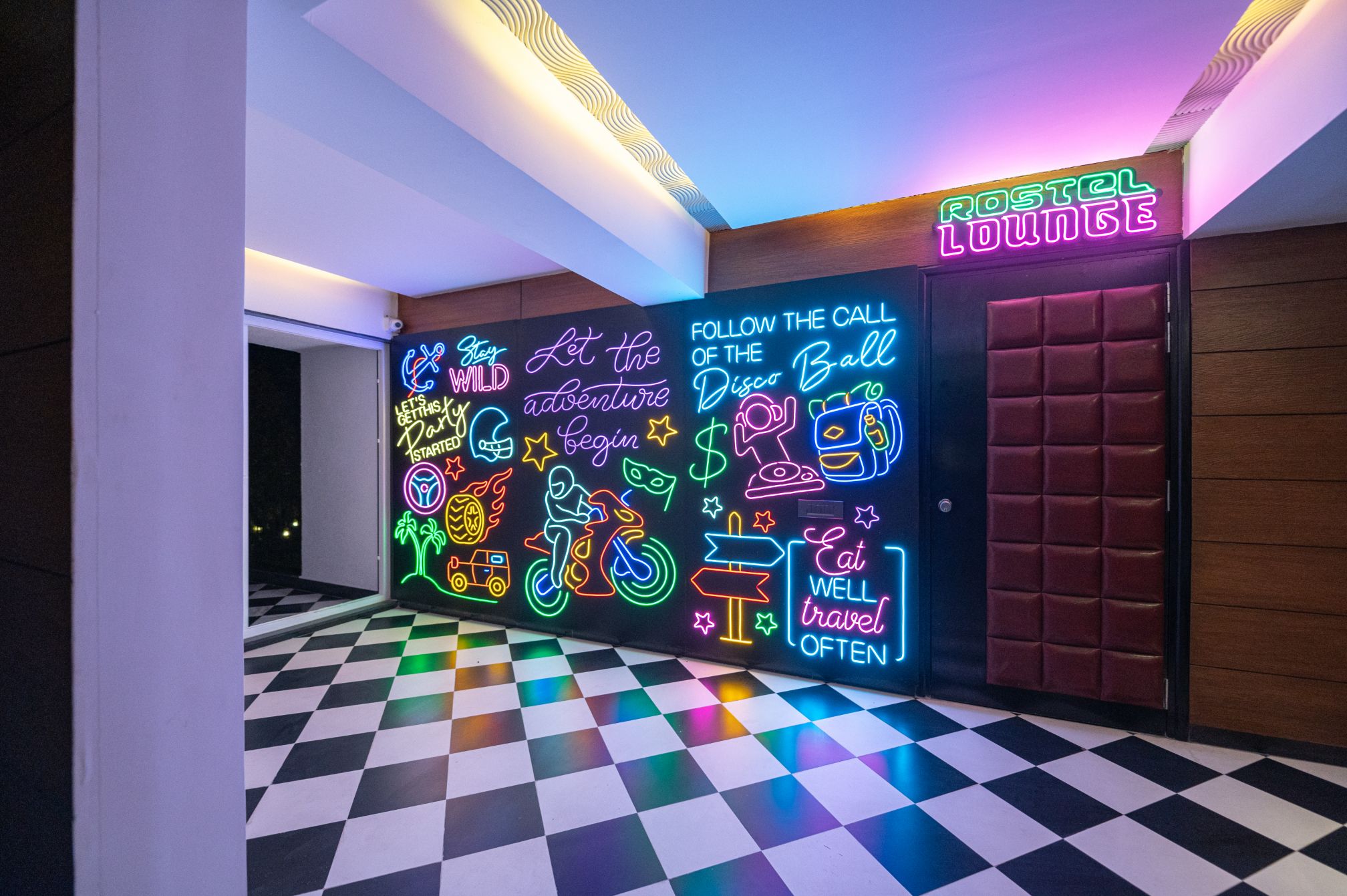 Colorful neon sign wall at Roadies Rostel, popular as a vibrant photo backdrop for celebrations and parties