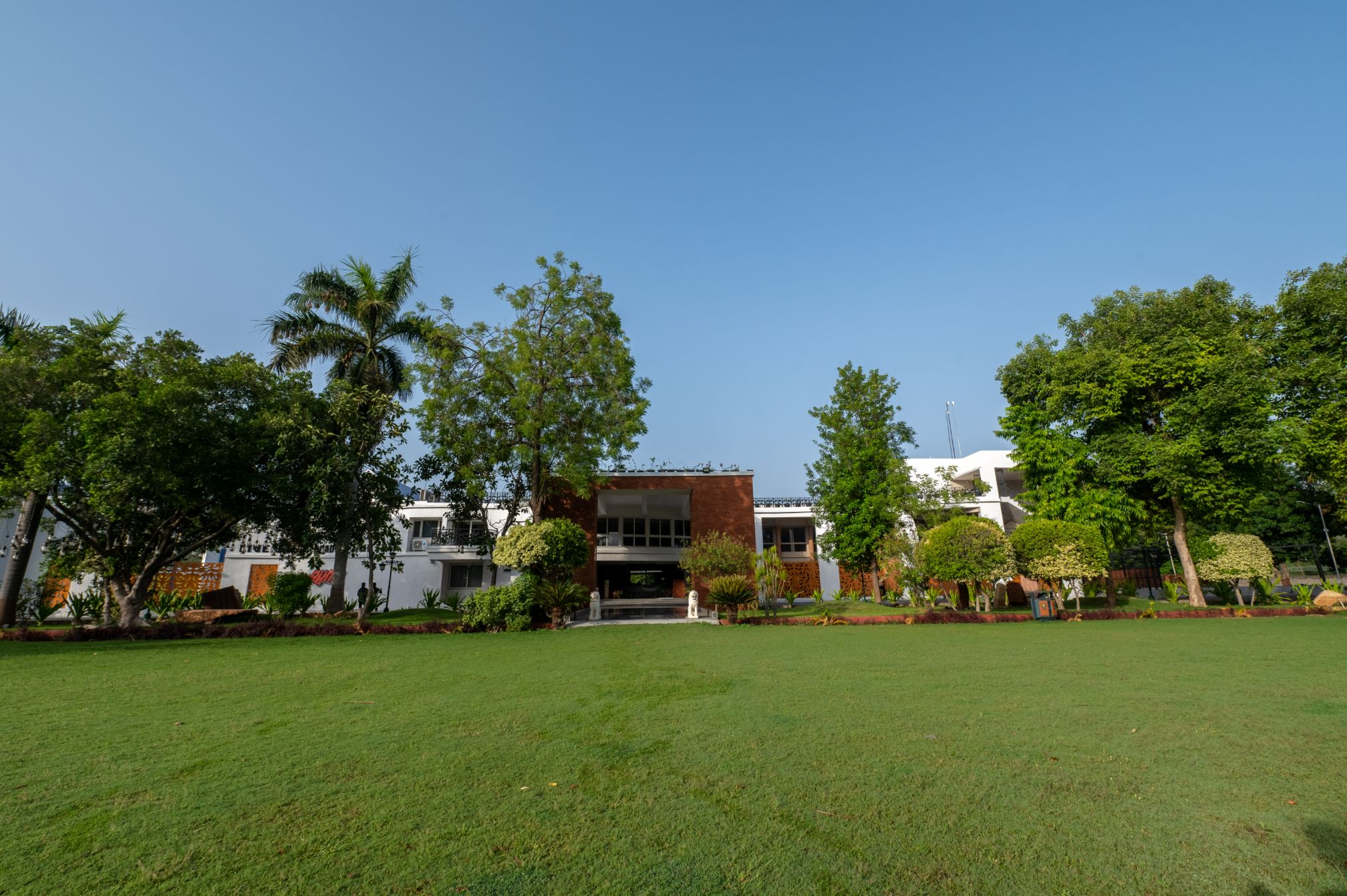 Expansive green lawn at Roadies Rostel perfect for family and kids' day picnic near Ahmedabad