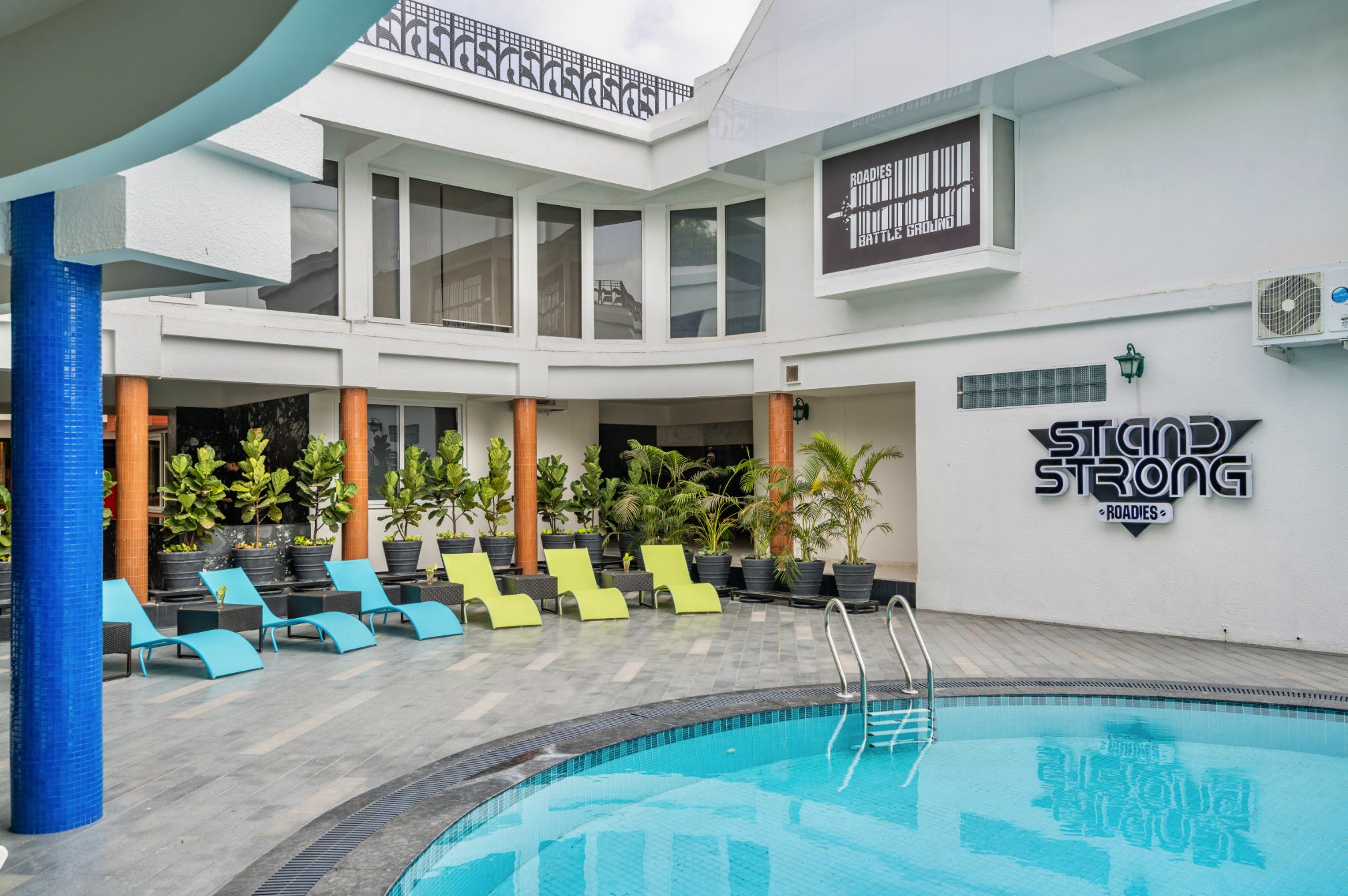 Relaxation zone with poolside loungers at Roadies Rostel ARC Resort for a refreshing one day picnic