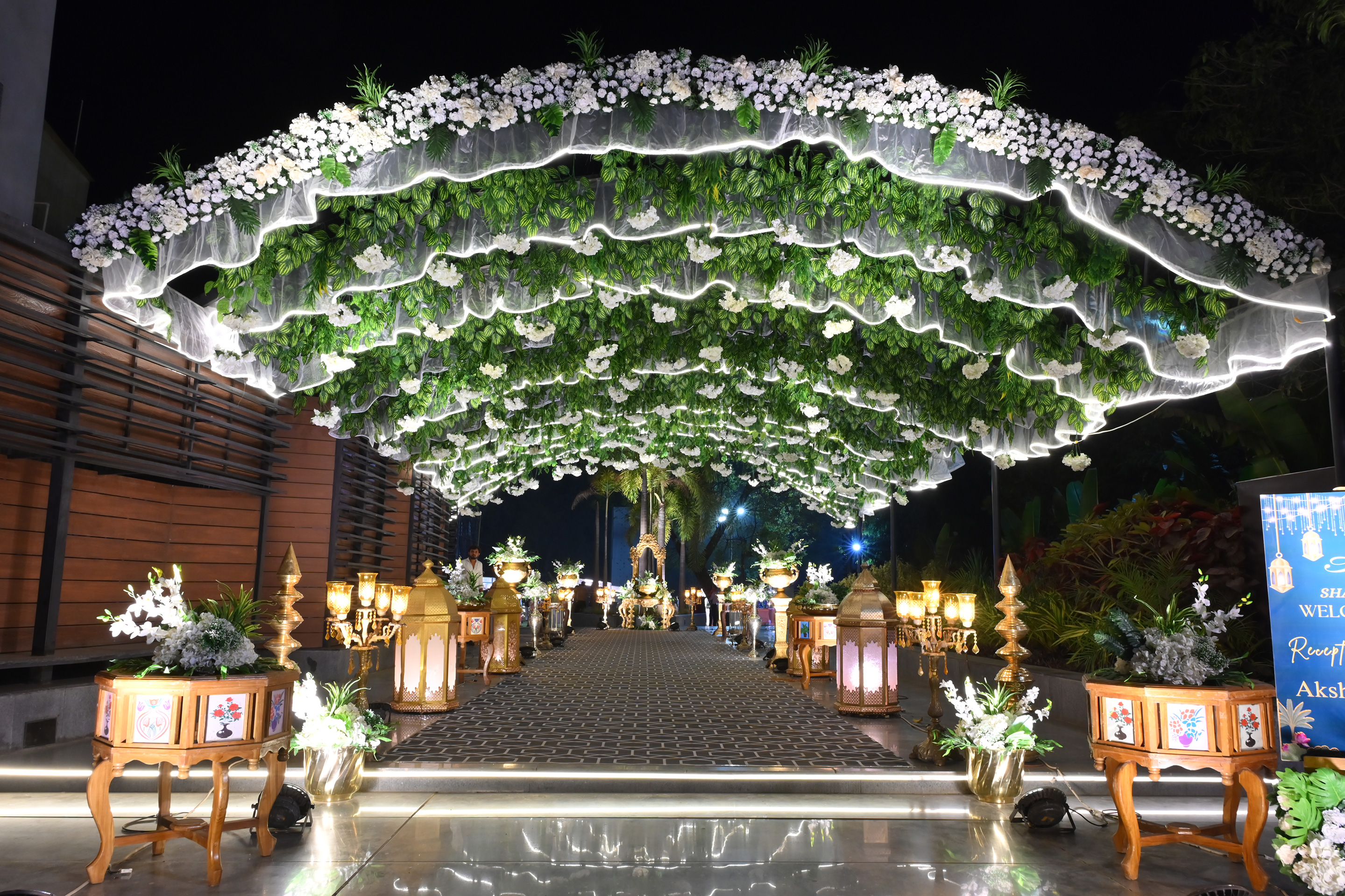 Elegant wedding entrance gate decorated with flowers and drapes at Roadies Rostel ARC Resort, ideal for royal celebrations near Ahmedabad.