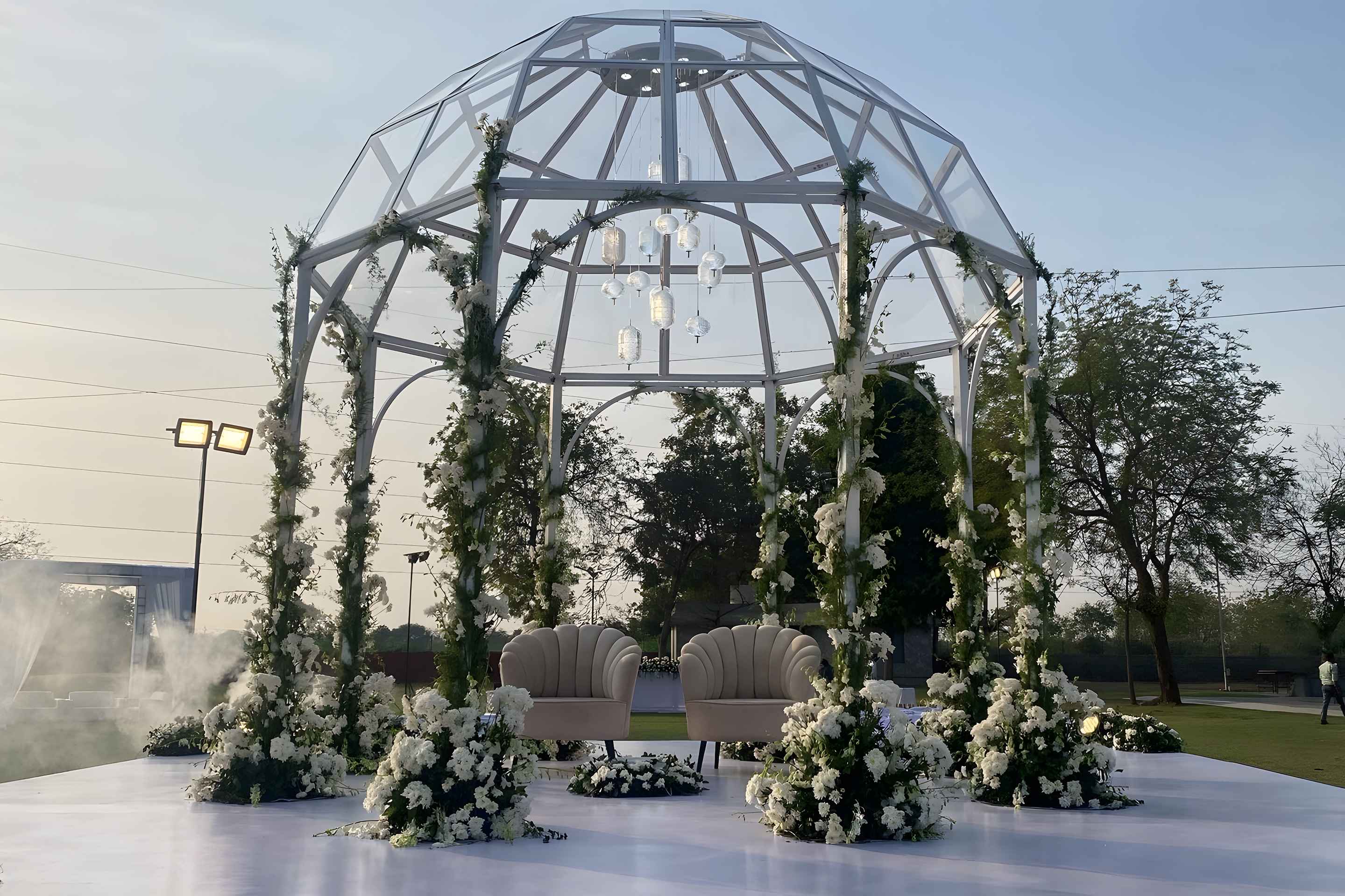 Reception venue decorated with lights and floral arrangements at Roadies Rostel ARC Resort, perfect for evening wedding celebrations.
