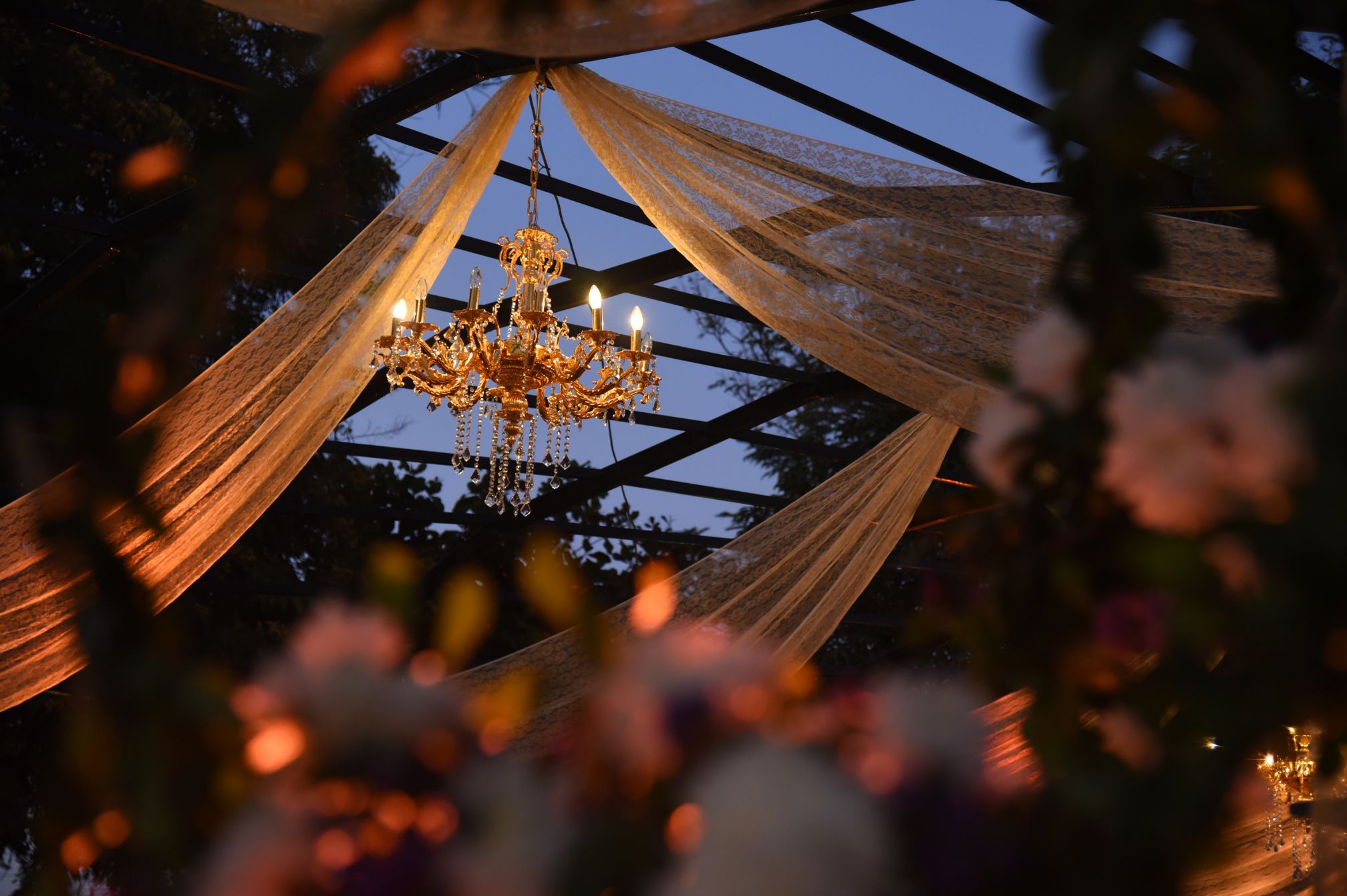 Detailed view of chandelier used in wedding decor at Roadies Rostel ARC Resort, adding a touch of grandeur to the celebration ambiance.