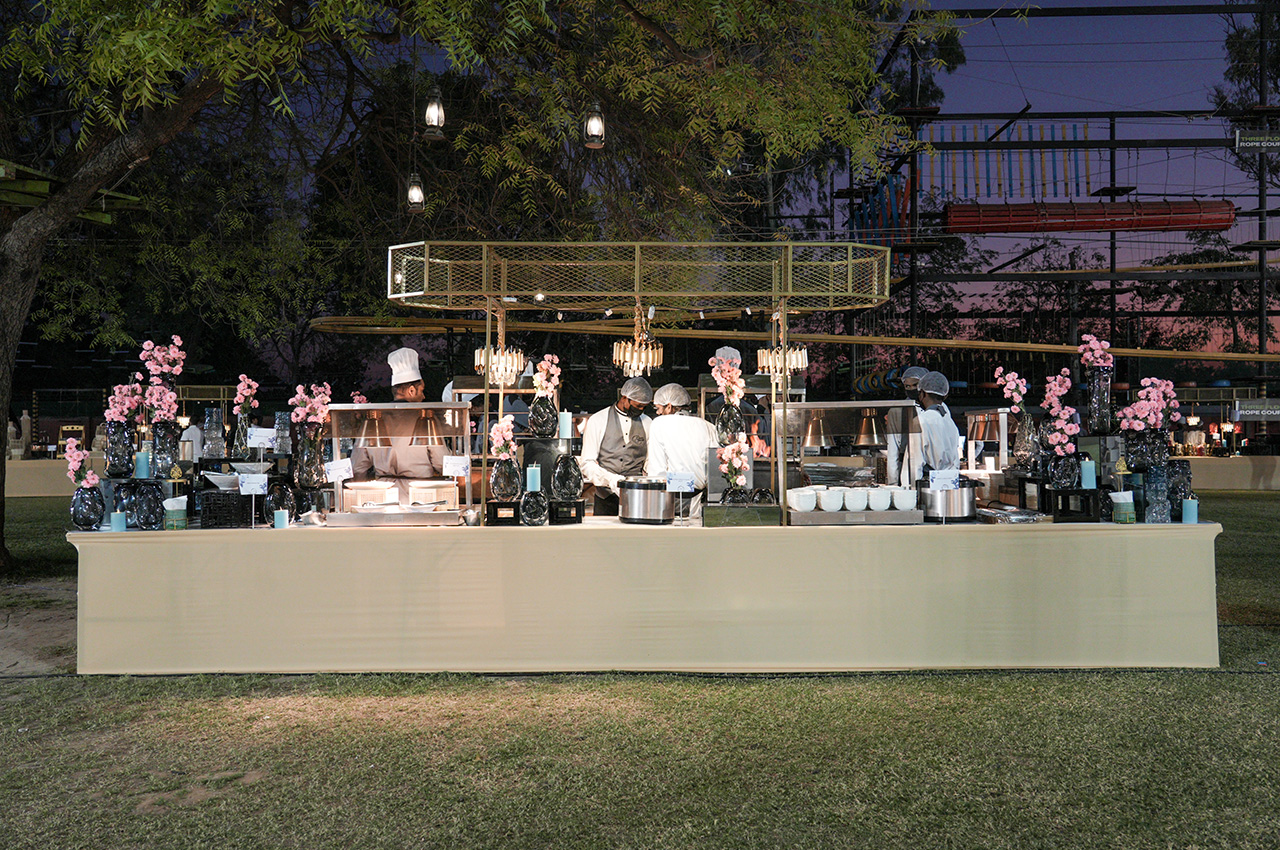 Elegant wedding table decor featuring candles and floral centerpieces at a top wedding venue near Ahmedabad.